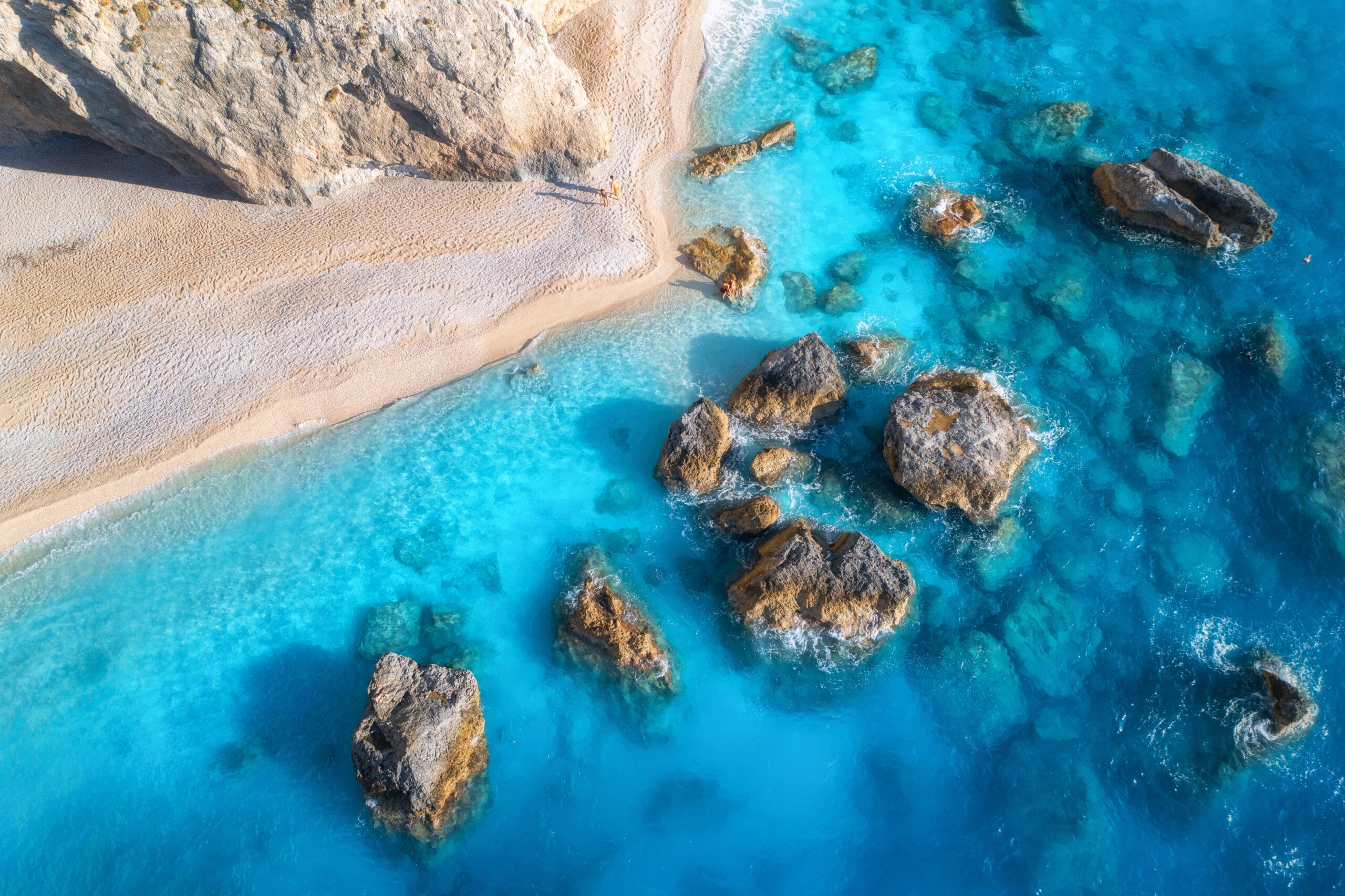 Aerial,View,Of,Blue,Sea,,Rocks,In,Clear,Water,,White