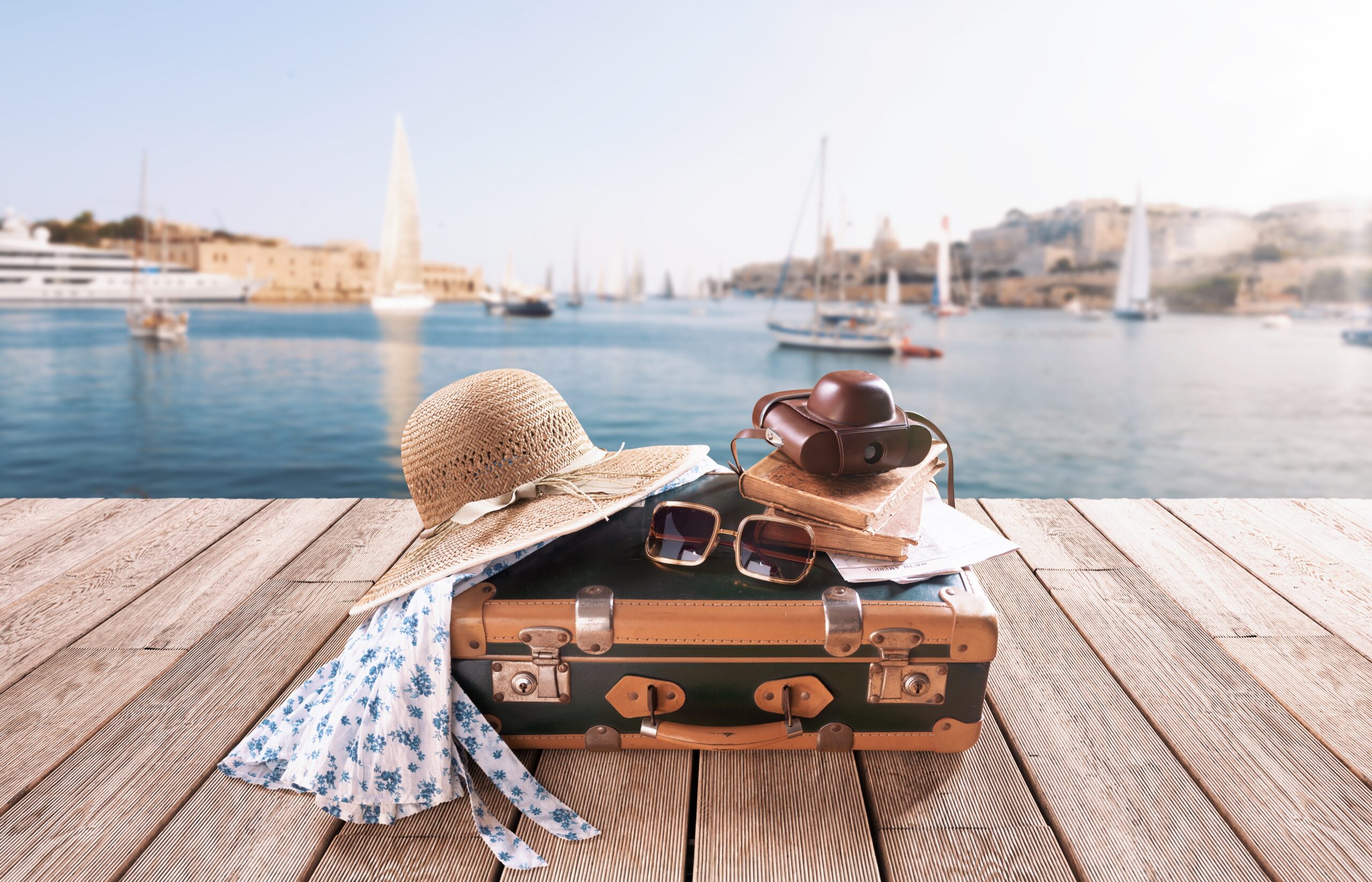 Vintage,Style,Suitcase,And,Accessories,On,A,Wooden,Deck,,City