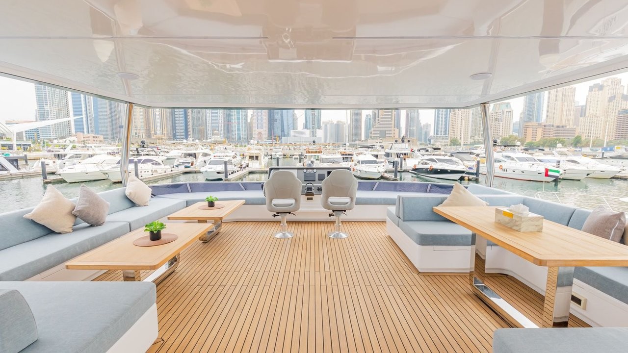 Infinity's lounge with panoramic windows, sofas and teak flooring